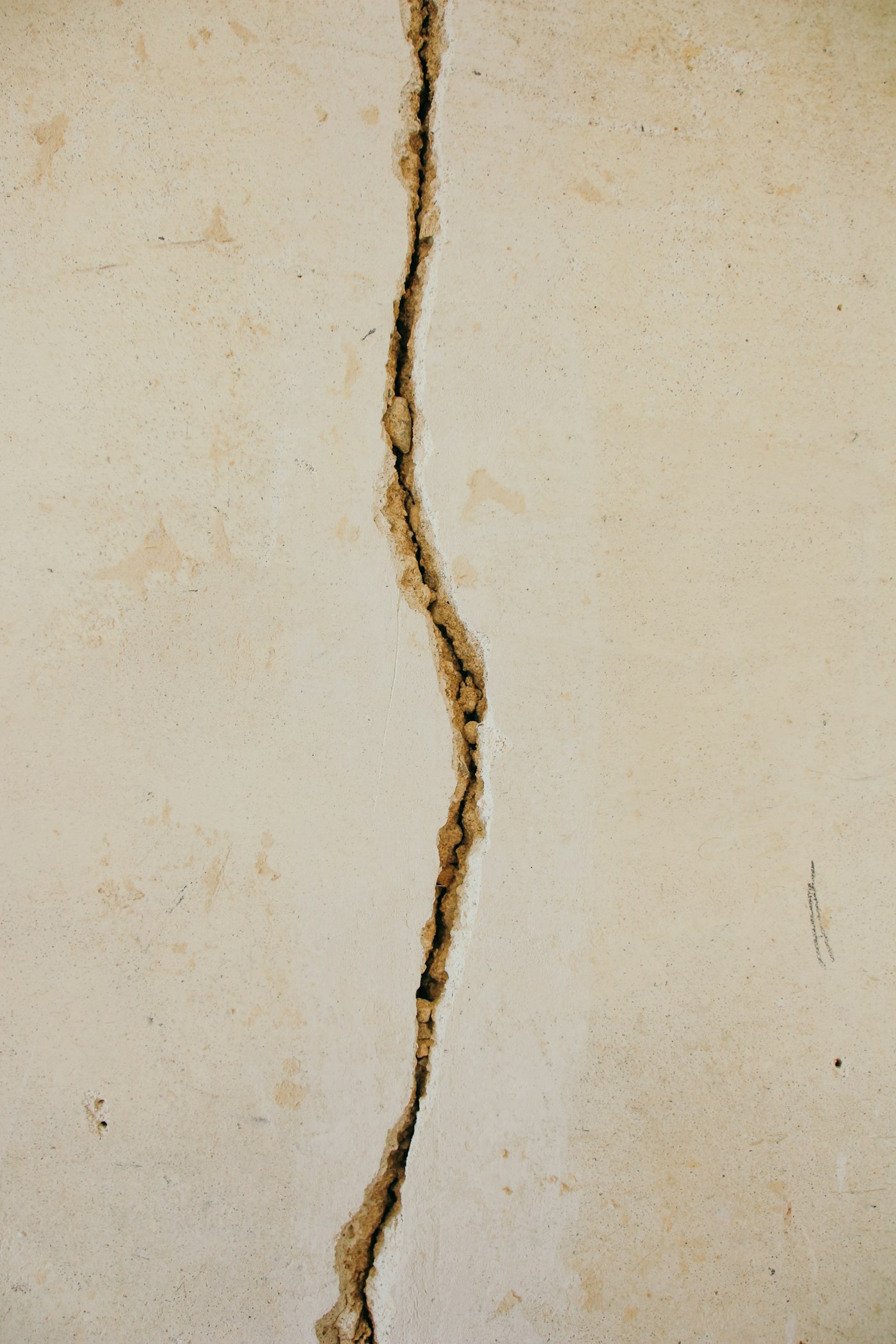 A wider crack with weathering and staining: water has been through this wall.