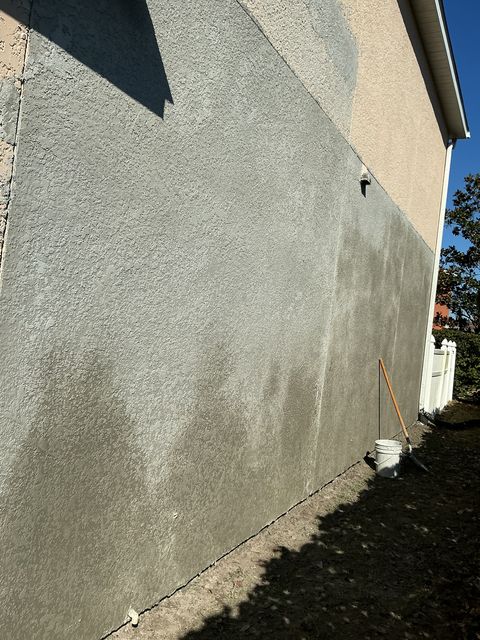 Long stucco wall showing consistent finish quality